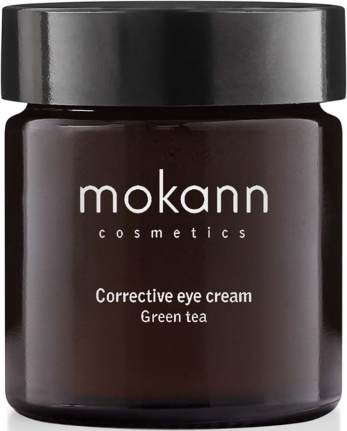 En mørk krukke med svart lokk merket 'mokann cosmetics'. Det er øyekrem med grønn te.