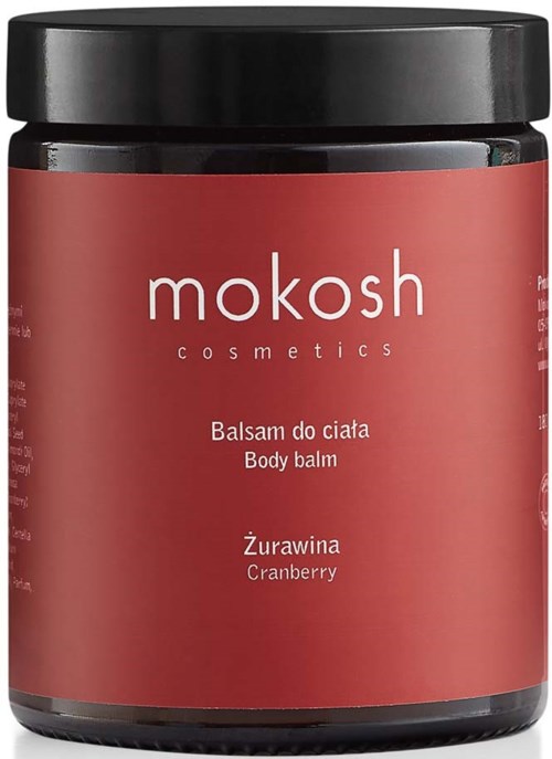 A jar of Mokosh body balm with a red label and black lid, featuring text in Polish and English about cranberry scent.