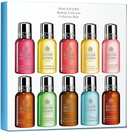 Multiple colorful bottles of Molton Brown bath and shower gels arranged in two rows, each with shiny silver caps.