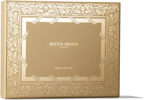 Gullfarget eske med blomsterdekor og tekst: Molton Brown, London, Made in England.