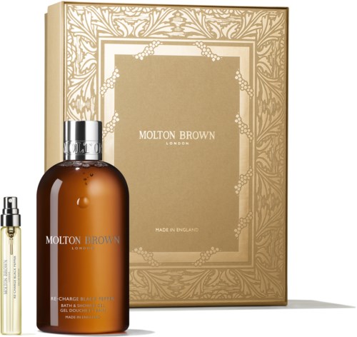 Set includes a golden box and bottles of Molton Brown bath and shower products, one large brown and one small clear bottle.