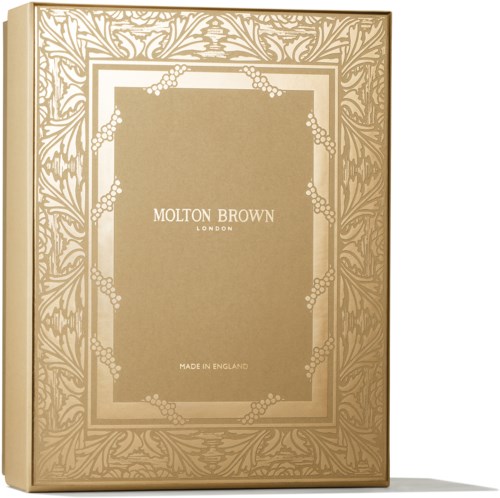 A decorative box with gold and beige colors, featuring floral and leaf patterns. It has text: "MOLTON BROWN LONDON" and "MADE IN ENGLAND."