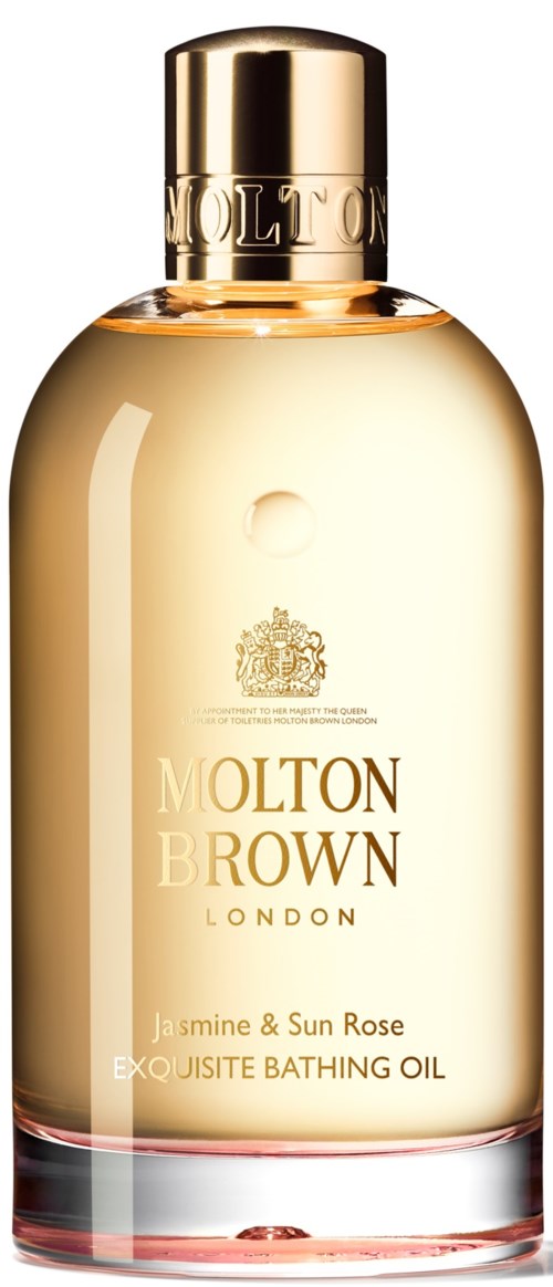 En flaska Molton Brown London badolja med jasmin och solros, guldkapsel och klart glas.