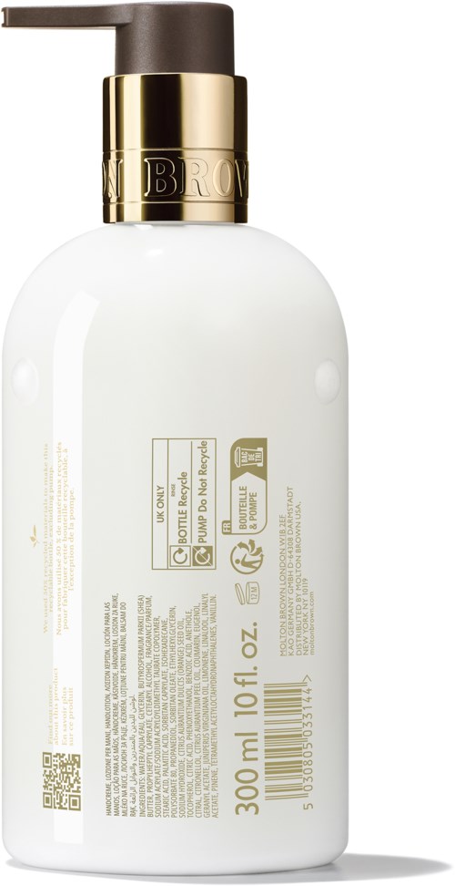 Hvit flaske med pumpe, gullkant og tekst, sannsynligvis lotion eller såpe.