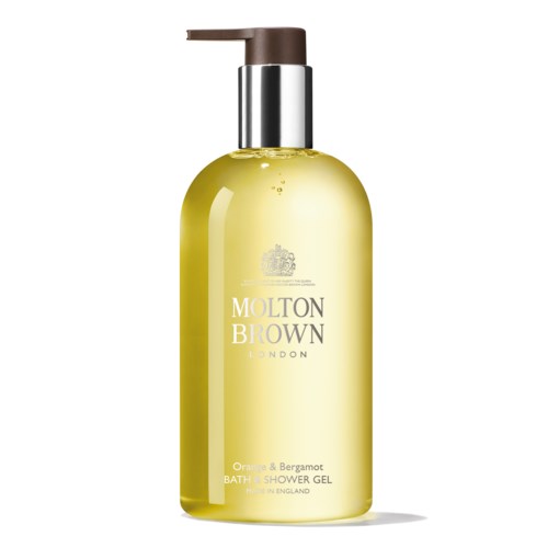 Gul shower gel-flaske med pumpe, mærket Molton Brown London, duft af appelsin og bergamot.