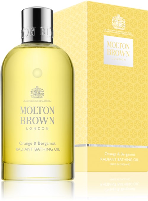 En gul flaska med Molton Brown badolja och en matchande gul box, båda har eleganta etiketter och silverlock.