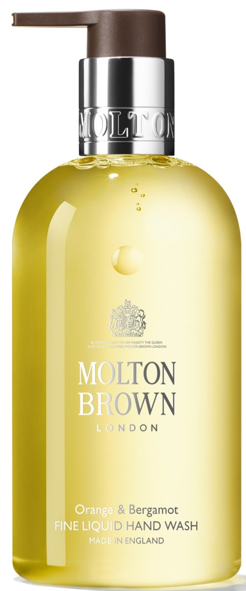 Żółta butelka do mycia rąk z brązową pompą i srebrnym pokrywą, oznaczona Molton Brown London, zapach pomarańczy i bergamoty.