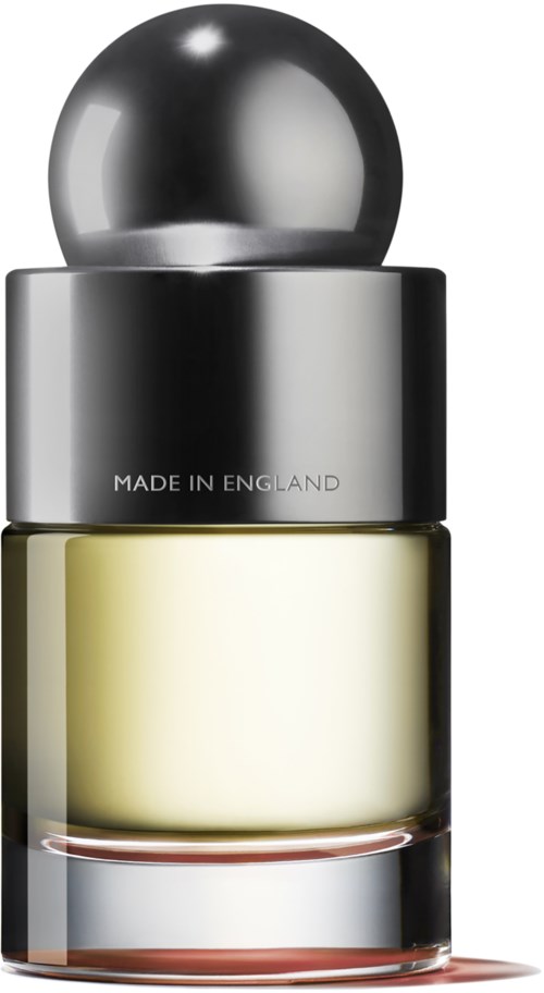 A perfume bottle with a silver cap, light yellow liquid inside, and text saying 'Made in England.'