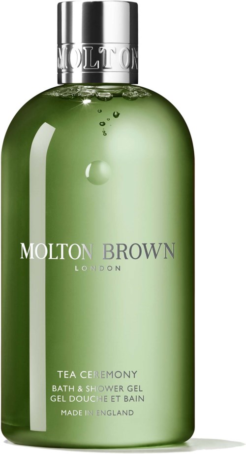 Grön bad- och duschgelflaska med silverlock, märkt 'Molton Brown London Tea Ceremony'.
