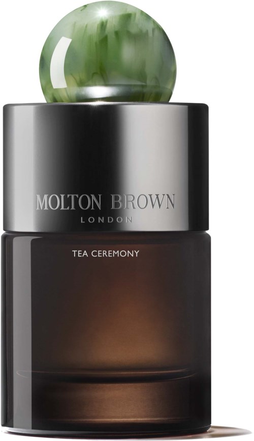 En Molton Brown London duftflaske med grøn boldhætte og mørk krop.