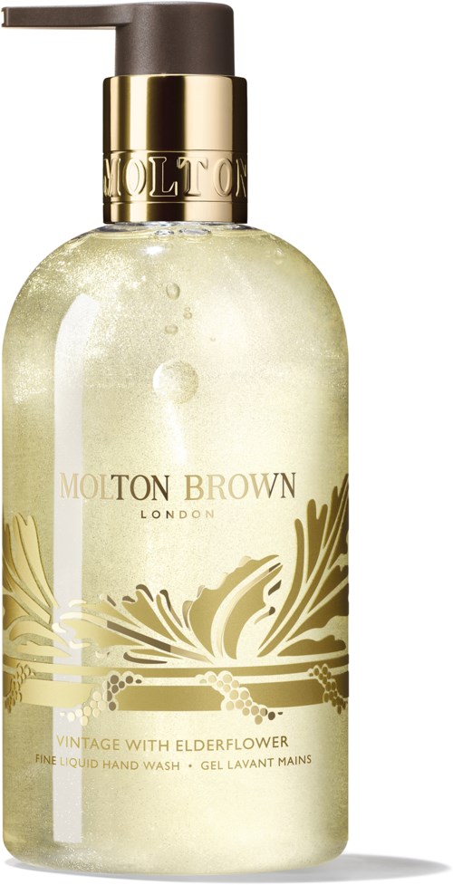 En flaske håndsåpe fra Molton Brown med gulldetaljer og blomsterdesign på etiketten.