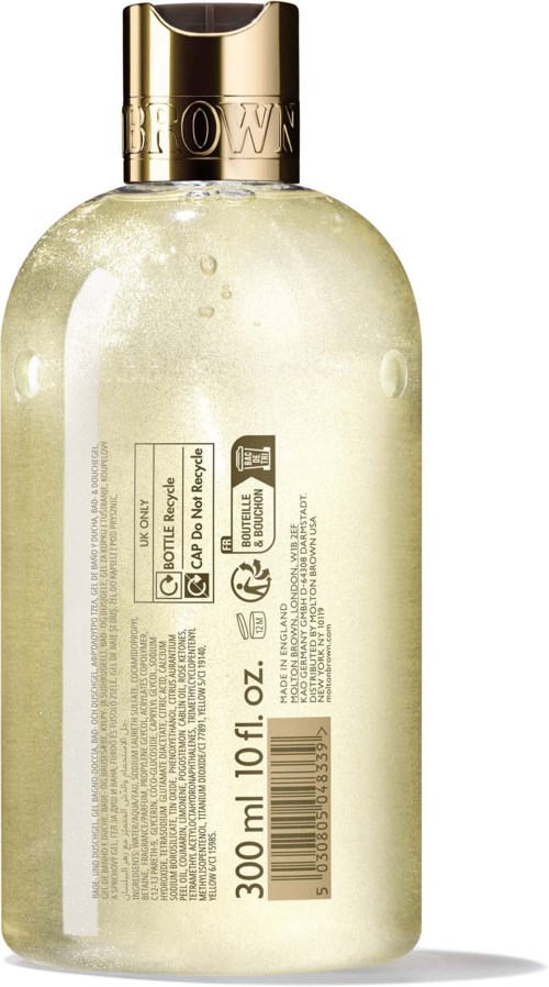 En gennemsigtig flaske med en guldkapsel indeholder kropslotion, der viser bagsiden med produktdetaljer.
