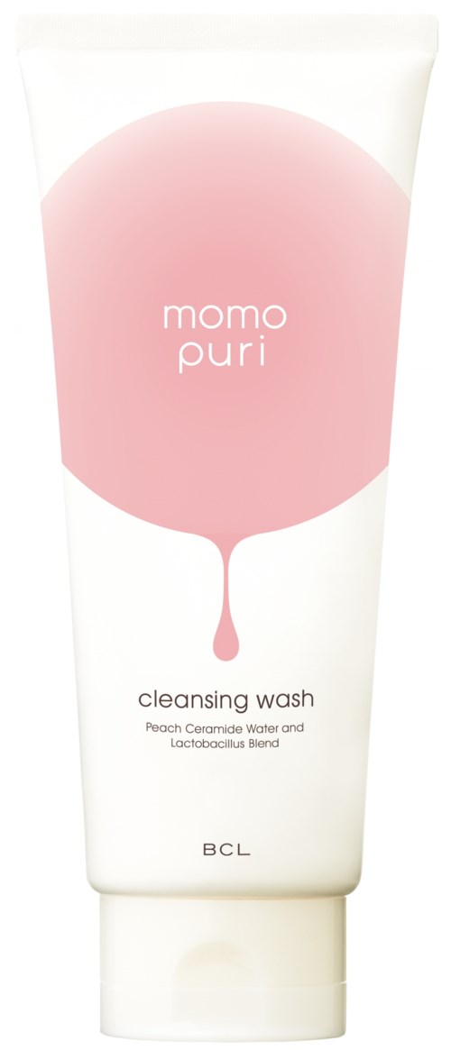 En vit tub med en rosa cirkel och droppdesign, märkt 'momo puri', 'renstvätt', innehåller persikavatten och probiotika.