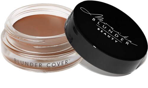 A jar with beige cream, labeled 'Blunder Cover' and a black lid with 'MARC JACOBS BEAUTY' on top.