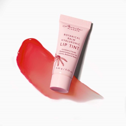 A pink tube of botanical lipstick balm with a red smear of product beside it.