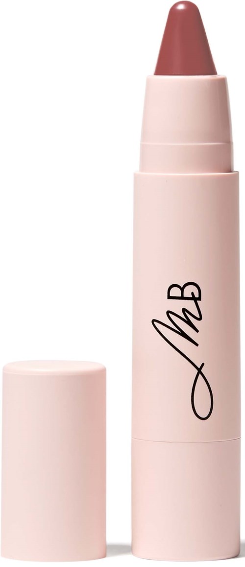 A beige lipstick stick with a cap, standing upright with a signature on it.