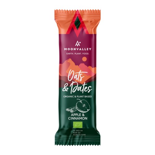 Een snackreep met de tekst 'Oats & Dates, Apple & Cinnamon' met kleurrijk ontwerp, merk en plantaardige ingrediënten.