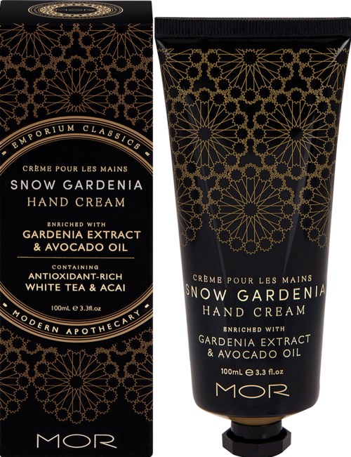 En svart og gull pakke og tube for Snow Gardenia håndkrem, dekorert med blomsterdesign, med vekt på viktige ingredienser og fordeler.