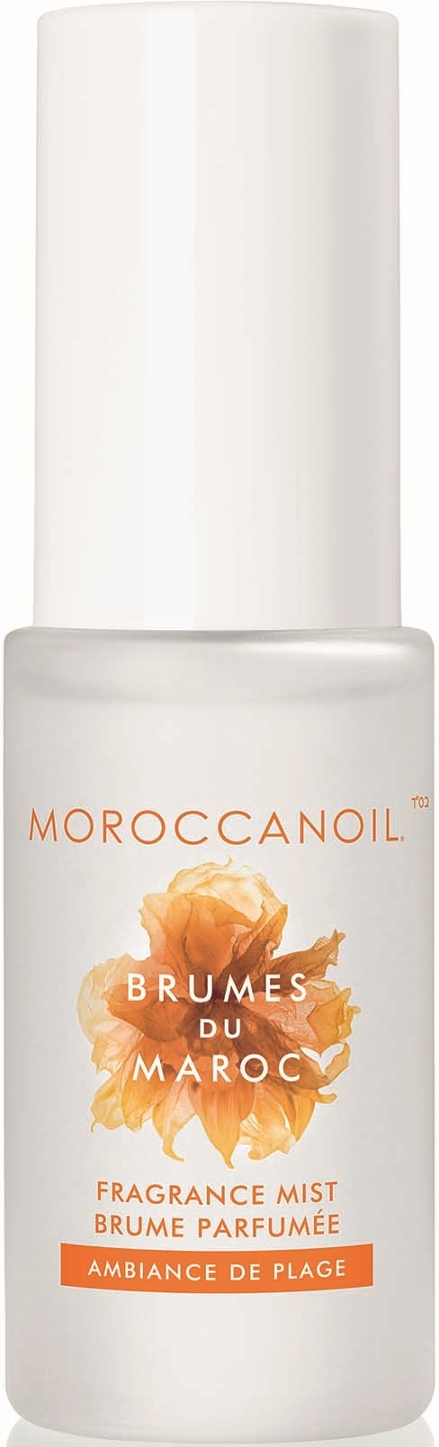 En vit sprayflaska märkt Moroccanoil med orange och brunt text, beskriver en doftmist för strandstämning.
