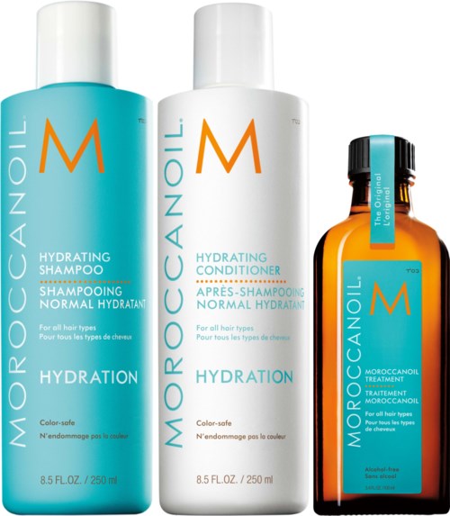 Drei Flaschen Moroccanoil Haarpflegeprodukte: Shampoo, Conditioner und Behandlung, alle mit orangefarbenen und türkisfarbenen Etiketten.