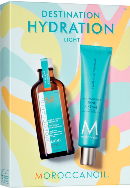 Box with MoroccanOil skincare products, a brown bottle and a blue tube on pastel background.