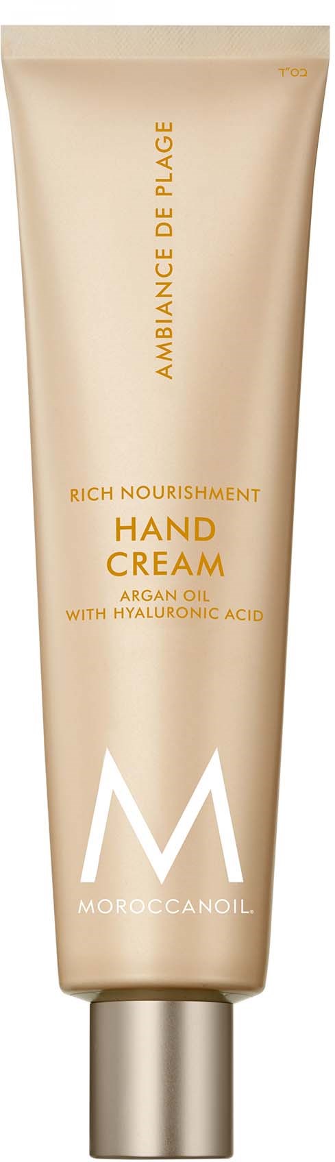En beige tube med håndkrems fra Moroccan Oil med gull og hvit tekst, elegant design og sølvkork.