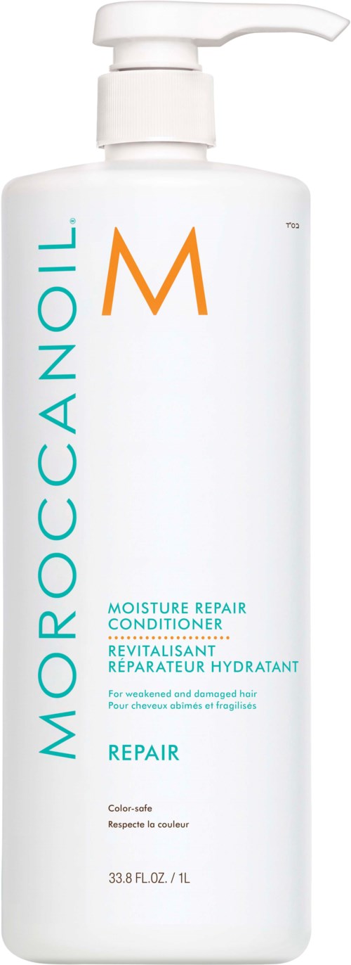 En vit flaska med pump, märkt Moroccanoil Moisture Repair Conditioner för skadat hår. Flaskan är lång och slank.