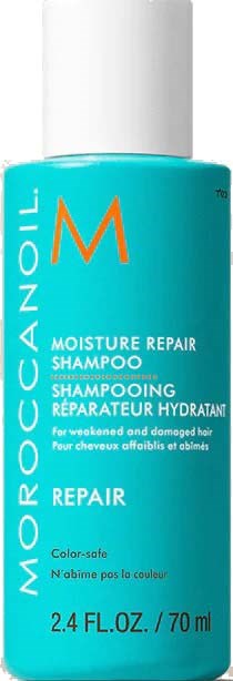 En blå flaska Moroccanoil Moisture Repair Shampoo med vit lock. Etiketten visar att den reparerar skadat hår, 70 ml.