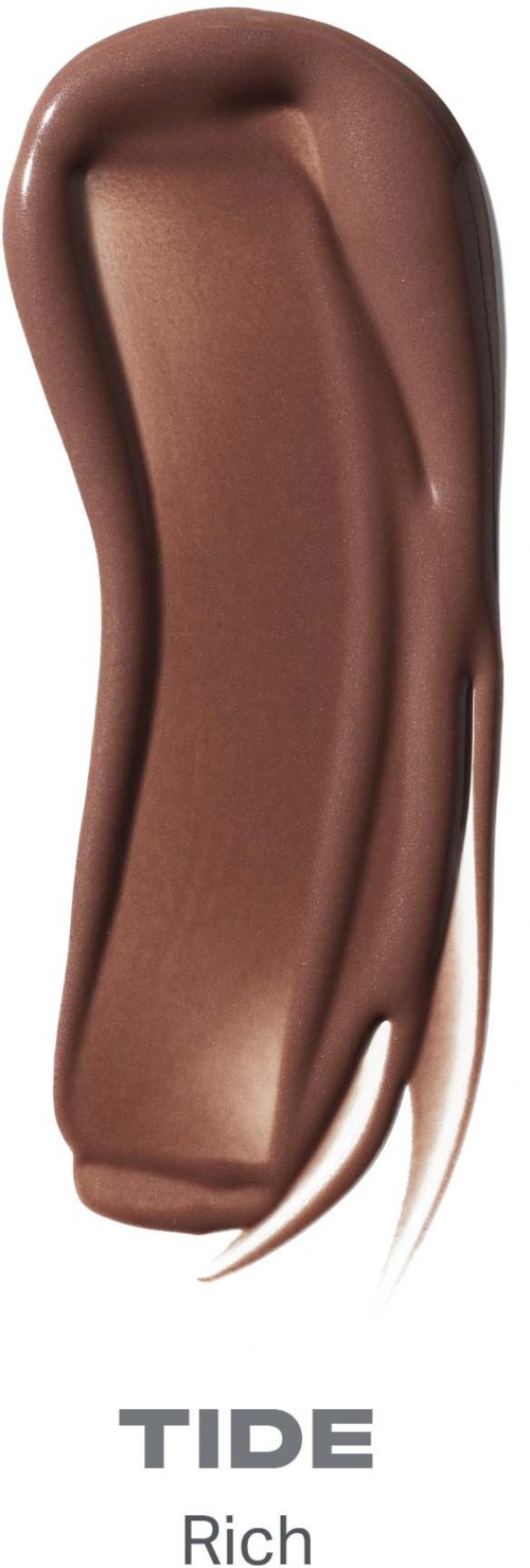 A swatch of TIDE Rich liquid foundation in a copper shade with a smooth, creamy texture.