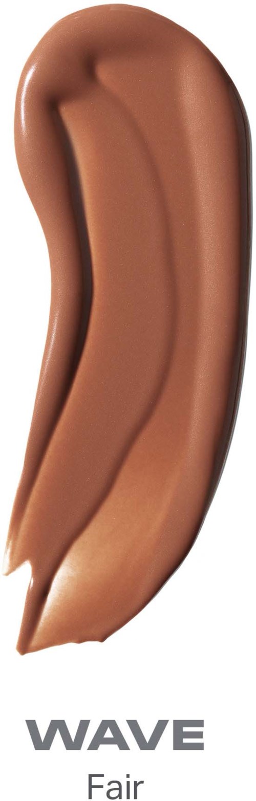 Creamy liquid foundation streaked on skin, labeled Wave Fair, with a smooth texture and light beige color.