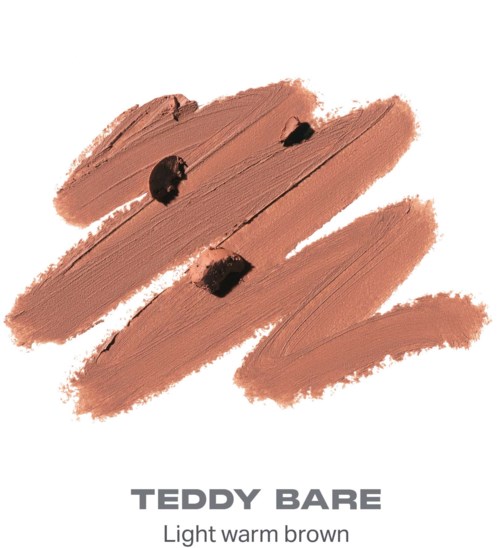 Makeup-swatch i lyst varmbrun farve med mørke pletter, viser en glat, blended tekstur.