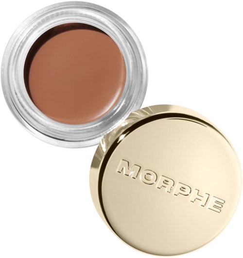 Liten krukke med brun krem og gulllokk som sier 'Blush'.