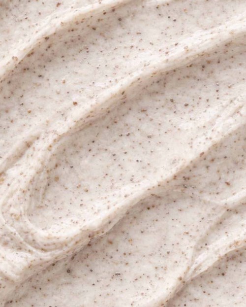 Close-up of a creamy, speckled ice cream or yogurt texture with smooth swirls.