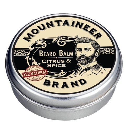 En rund behållare för skäggbalsam märkt 'Mountaineer Brand' med en bearded man och en 'all natural'-stämpel.