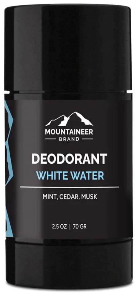 A black deodorant stick with a mountain logo, labeled "White Water" with mint, cedar, musk scents.