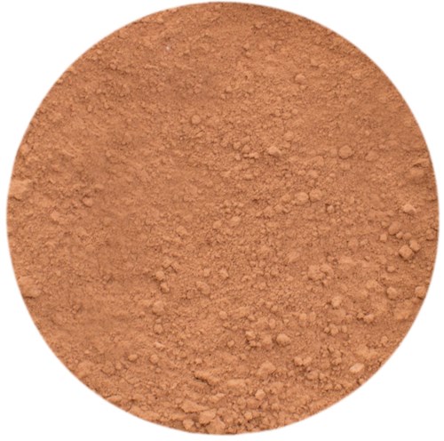 En rund behållare fylld med orangebrun pulver, möjligen kakao eller kanel.