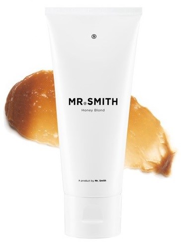 En hvit tube merket 'MR. SMITH Honey Blond' med honningboller i bakgrunnen.