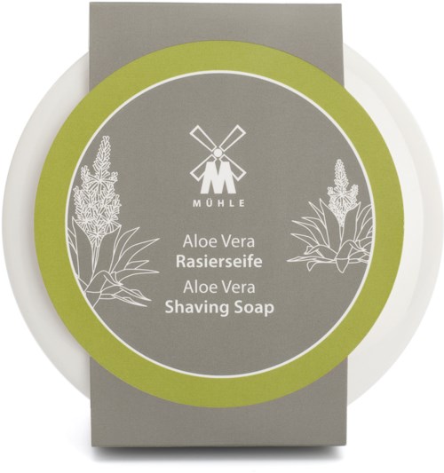 En förpackning med aloe vera skäggtvål med illustrationer av aloeplantor, gröna och grå färger, och en väderkvarnslogo.