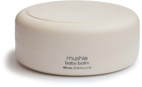 Eine runde, weiße Dose mit der Aufschrift 'mushie baby balm', 100 ml, zur Beruhigung der Babyhaut.