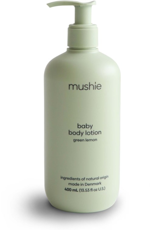 Eine weiße Flasche mit Pumpspender enthält mushie Baby-Bodylotion mit grünem Zitronenduft.