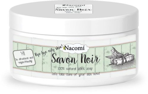 En vit burk med Nacomi Savon Noir, svart tvål med grön etikett, vegansk och naturlig, med presentlåda.