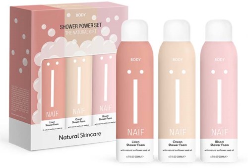 Set med tre shower foam-flaskor i rosa, persika och ljusrosa färger, märkta Naif Natural Skincare med förpackning.