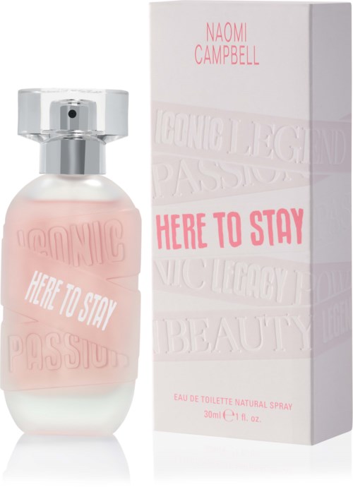 En parfyllflaska och box för 'Here to Stay' av Naomi Campbell visas, med ljus rosa och vita färger.