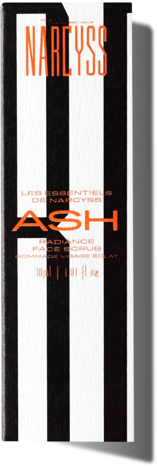 Een lang doosje met zwarte en witte verticale strepen en oranje tekst, noemt Narcissus, Ash en gezichtsscrub.