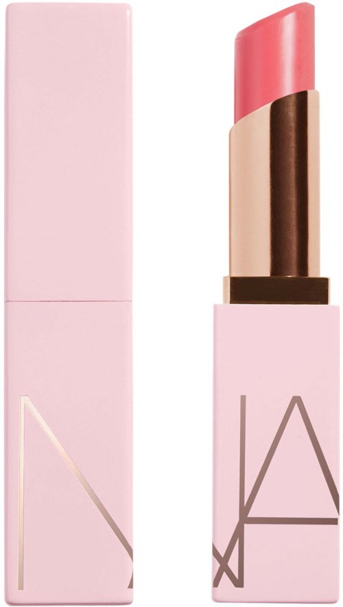 A NARS lipstick in a pink case with a light pink lipstick bullet inside.