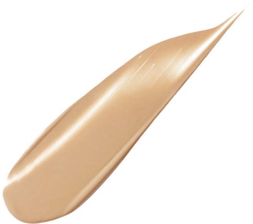 Et beige sminkeprodukt med glatt, rundet form og en spiss, spiss ende.