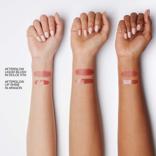 Three arms with different skin tones show swatches of liquid blush and lip shine for comparison.
