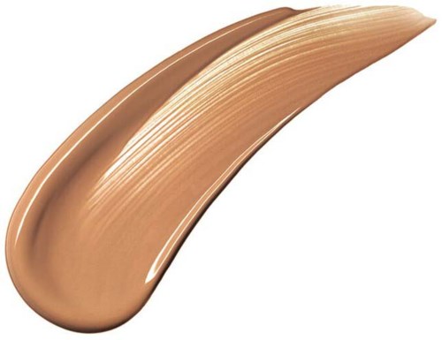 En tjock, kurvad strimma av beigefärgad cream eller makeupprodukt på vit bakgrund.