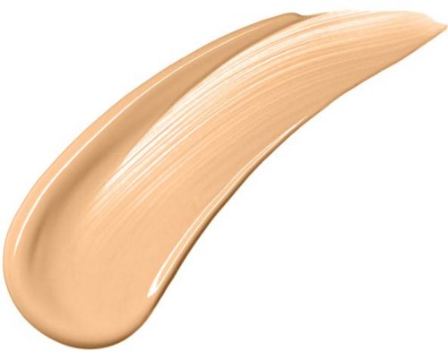 Een beige, romige make-up- of huidverzorgingsproduct uitgesmeerd in een streep.
