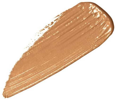 Ein beigefarbiges Make-up-Produkt, vermutlich Foundation, aufgetragen in einem dicken Strich mit sichtbaren Pinselstrichen.